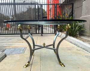 Amazing table brushed steel with gold animal hardware topped with 1” thick round glass top